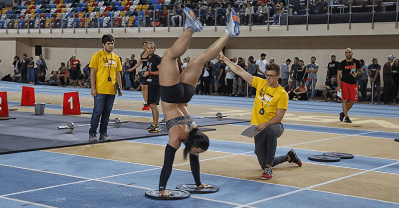 Female Crossfitter handstand-walks