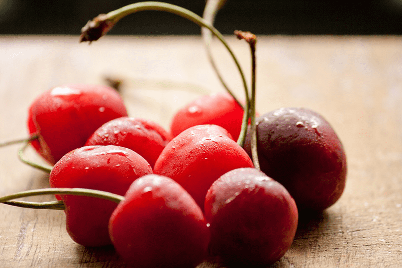 superfoods cherries in a bunch on a wooden table