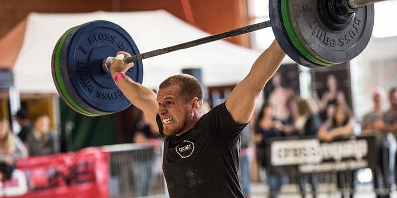 crossfitter snatch barbell lift with full hydration