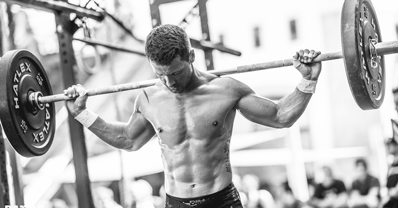 crossfit guy squatting with barbell wods at home