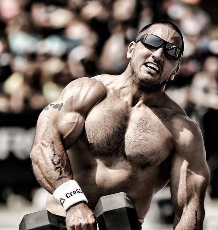 Crossfit athlete Jason Khalipa performs dumbbell snatches in competition