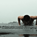 freeletics male athlete press ups in rain
