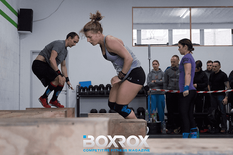 crossfit athletes performing box jumps during competition