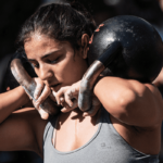 female athlete crossfit training kettlebells