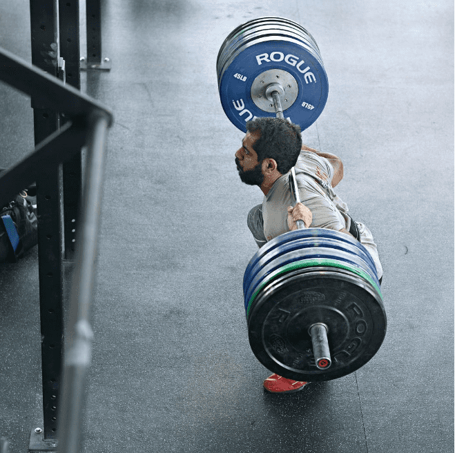 male crossfit athlete performs back squat