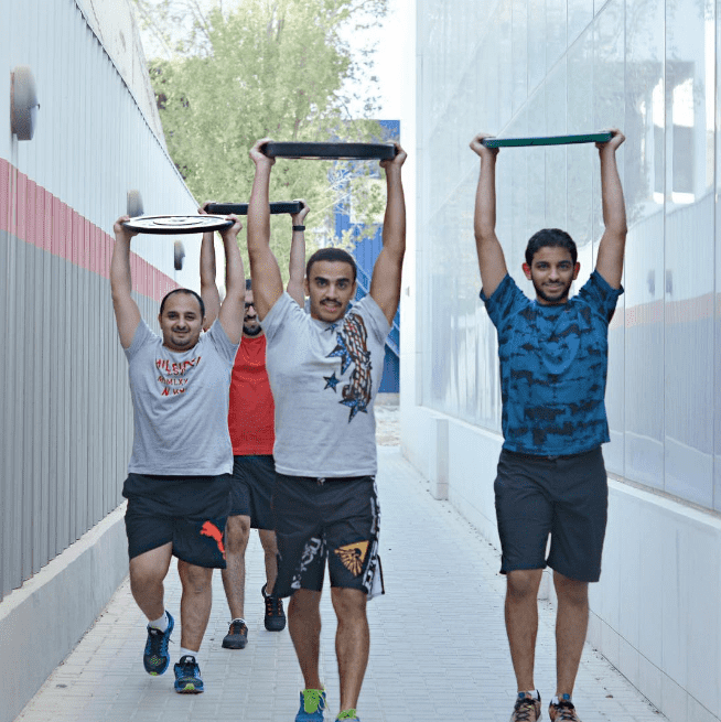 male kuwaiti Crossfitters carrying plates