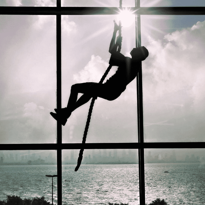 crossfit athlete climbs rope