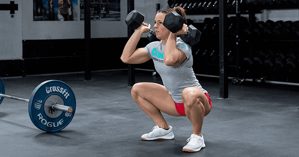 When doing dumbbell squats, is it better to hold them by your side