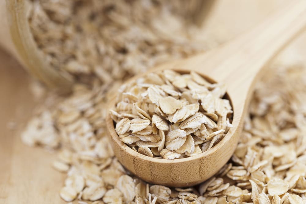 Healthy dry oatmeal in a wooden spoon