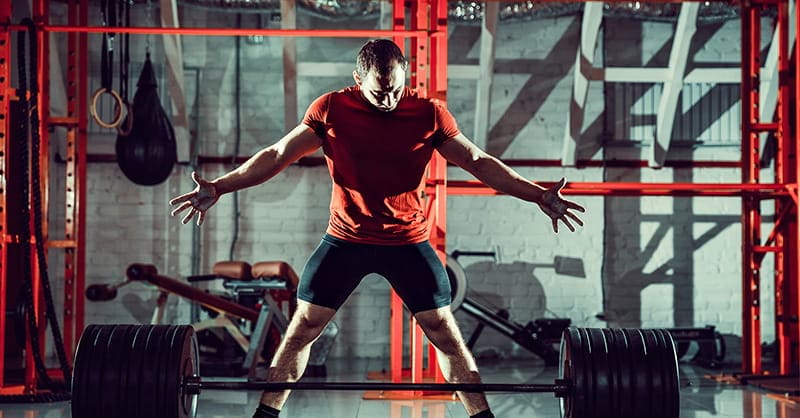 Sumo Deadlift set up young male athlete