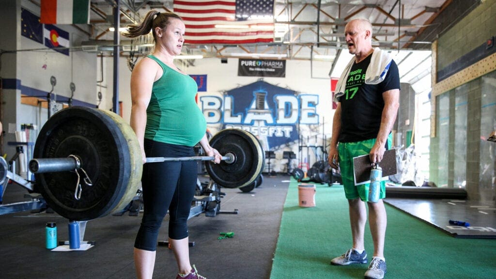 pregnant athlete performs deadlift back workouts