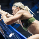 athlete ascends pegboard during workout
