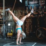 dani speegle performs gymnastics abs workouts with handstand hold