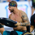 crossfit seated adaptive athlete with barbell plate