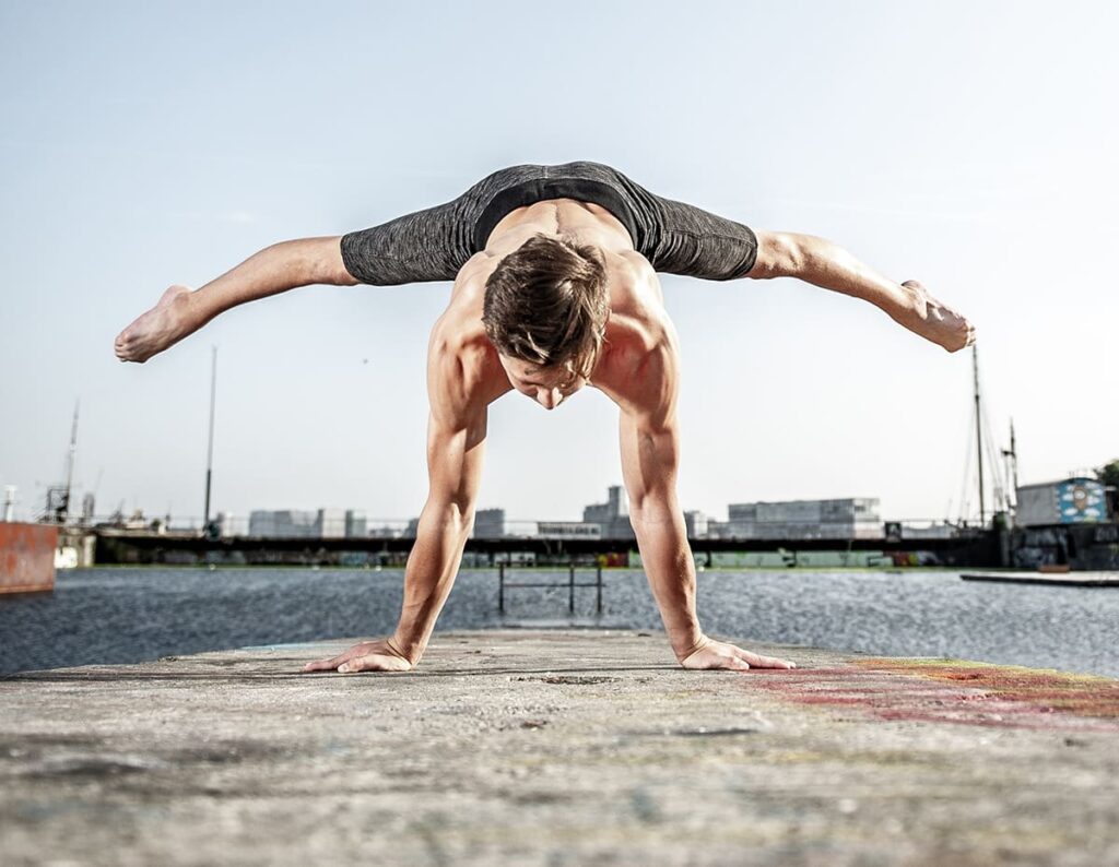 Man performs handstand showcasing Health in Movement