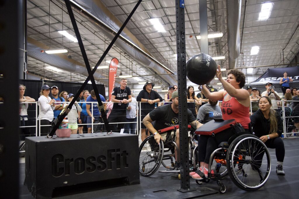 adaptive athlete performs wall balls during fitness competition