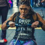 woman training hard on indoor rowing machine