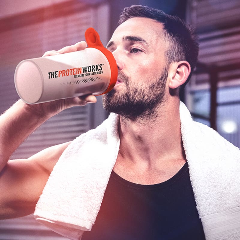 Man drinking protein from shaker