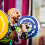 man performs different rep ranges of front squats in the gym