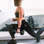 athlete performs Bulgarian split squat with dumbbell How to Get Bigger Legs