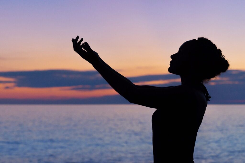 person does morning meditation by the beach