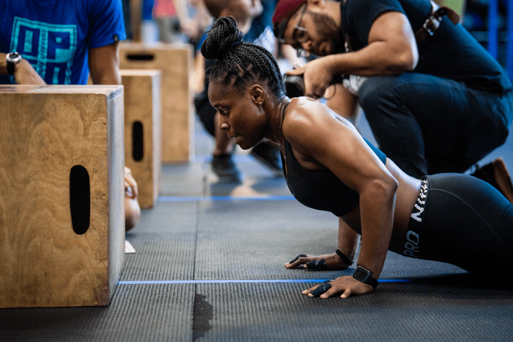 athlete performs functional burpee over box