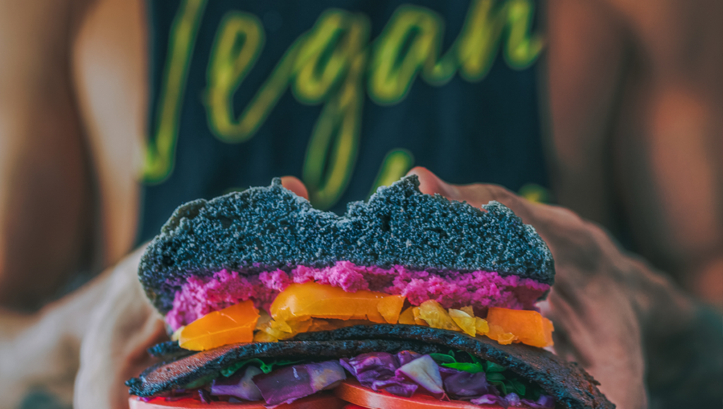 vegan sandwich held by a fit person