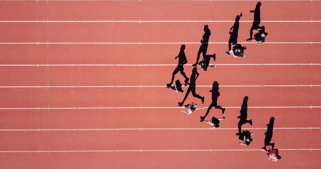 aerial view of group of runners on a track