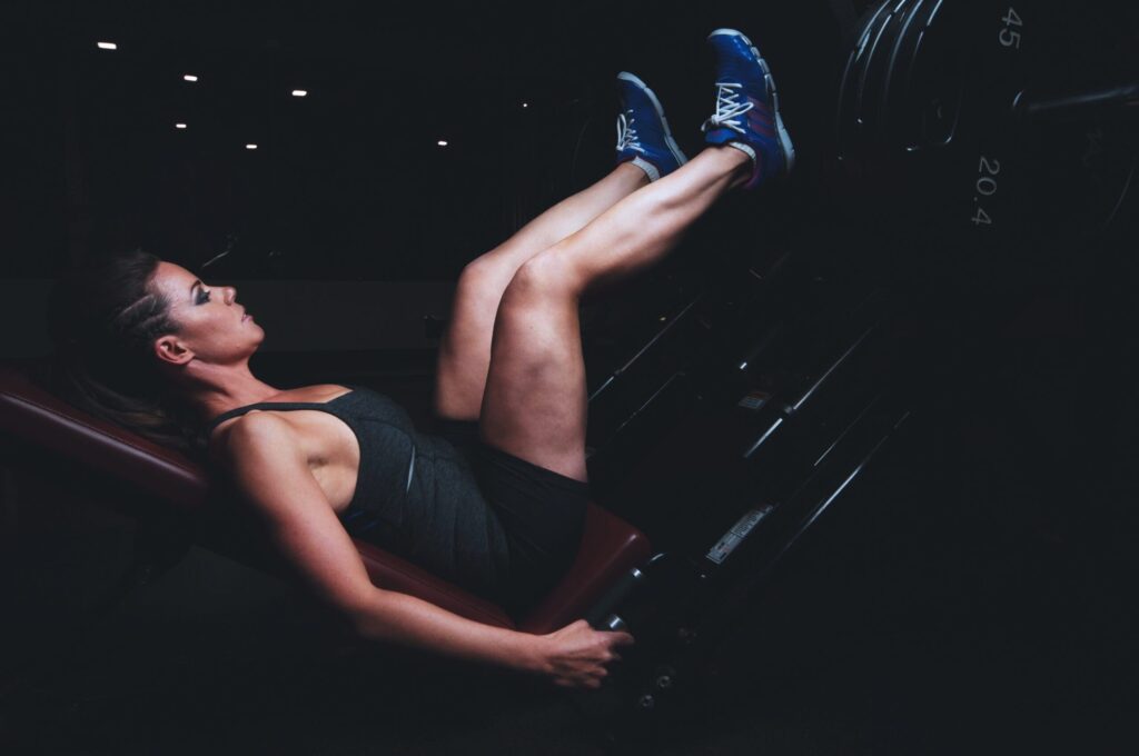 Woman does leg press at the gym