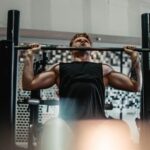 man lifts barbell