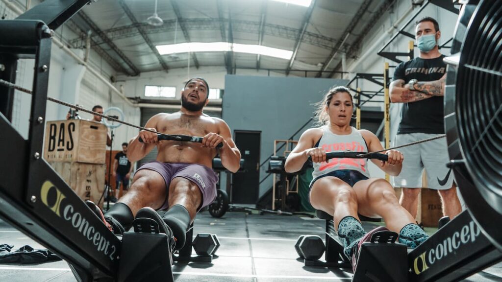 team athletes working out on rower