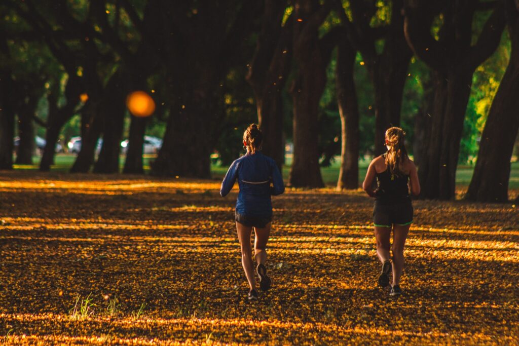 two runners in a park in autumn learn to love running