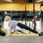 woman performs hip thrust variations in gym