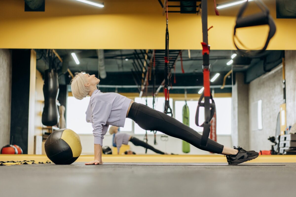 woman performs hip thrust variations in gym