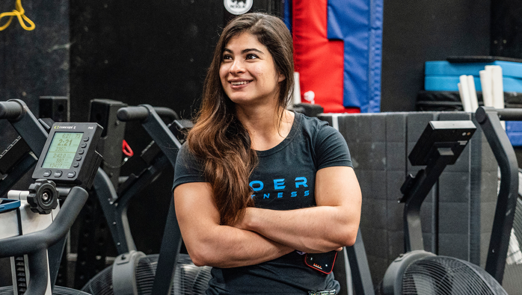 Ana Maria Valladares Arriaga smiles at the camera in the gym