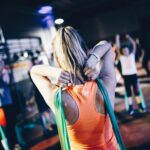 group of athletes performs the best exercises with a resistance band