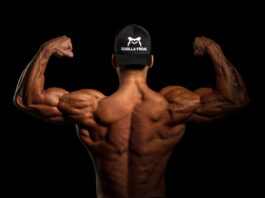 bodybuilder shows off back muscles