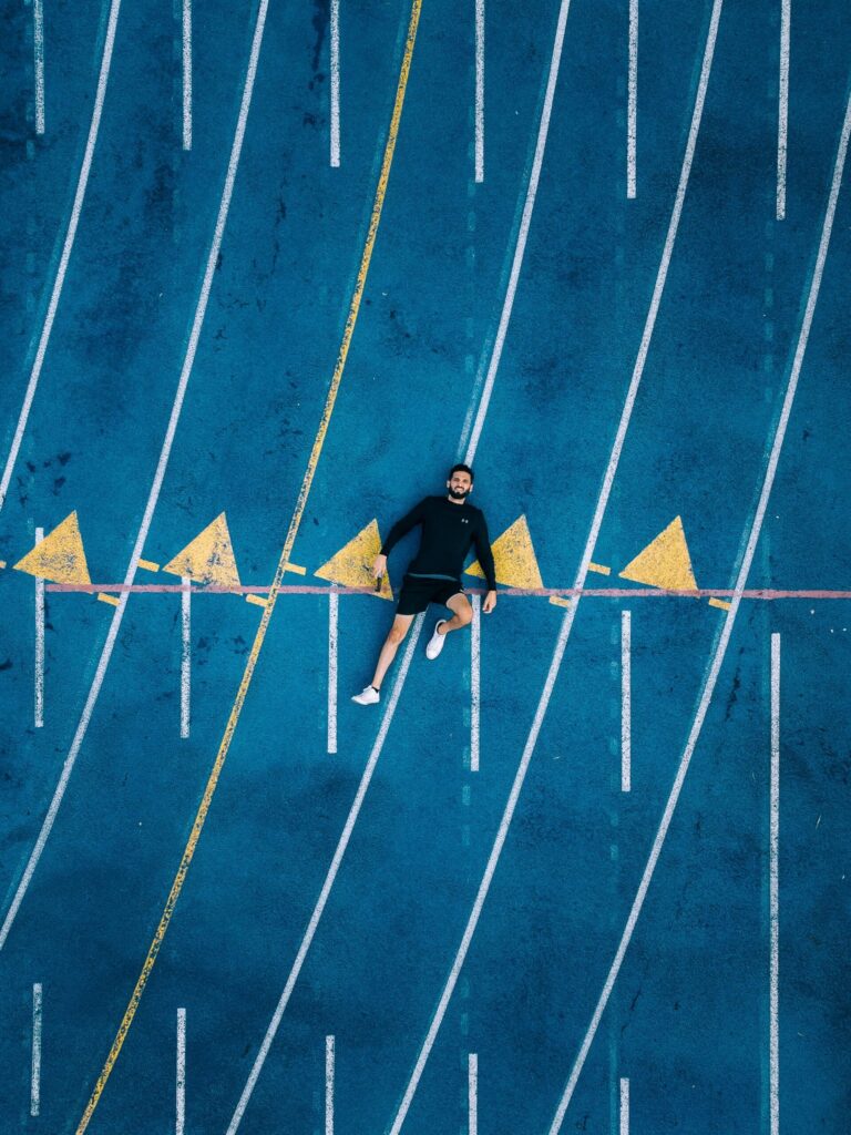 runner lies on the floor after a hard track workout