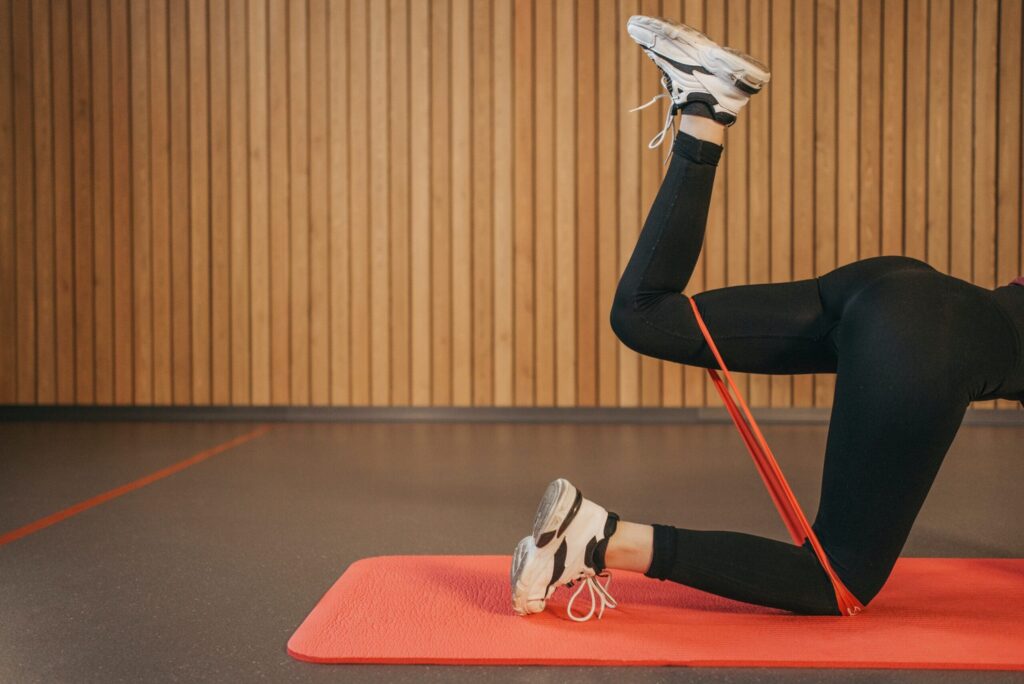 a pair of legs performing resistance band exercises