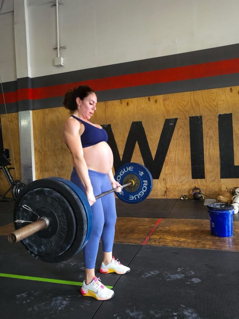 pregnant athlete perform deadlift during CrossFit open