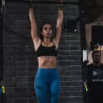 athlete hangs from barbell