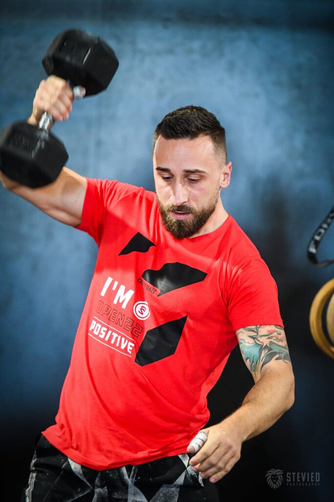 athlete performs dumbbell snatch during crossfit open Movement Standards for CrossFit open Workout 23.2