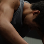 Man in gym struggling to workout and burning out