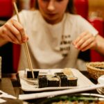Woman Eating Sushi