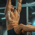 Man doing Hanging Leg Raise Ways to Stay Consistent With Ab Training