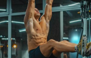 Man doing Hanging Leg Raise Ways to Stay Consistent With Ab Training