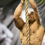 Athlete climbing rope