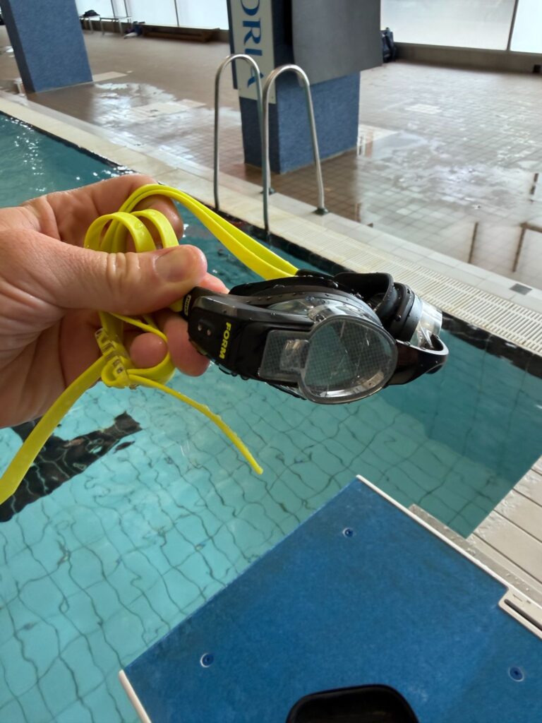 FORM Smart Swim Goggles next to pool